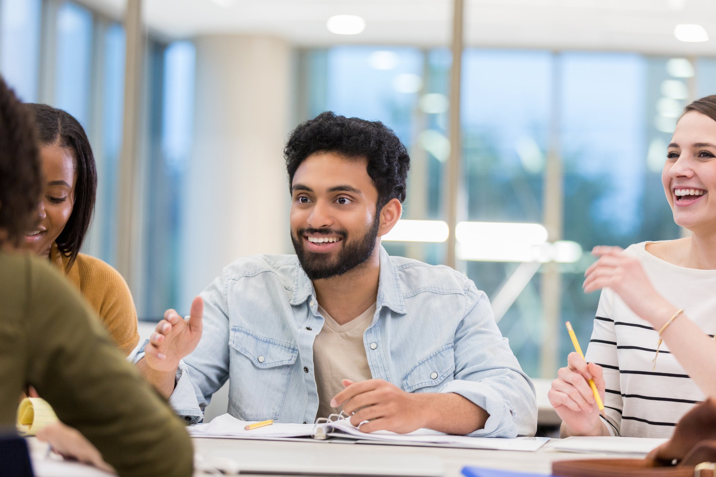 Indian male college student studies with friends