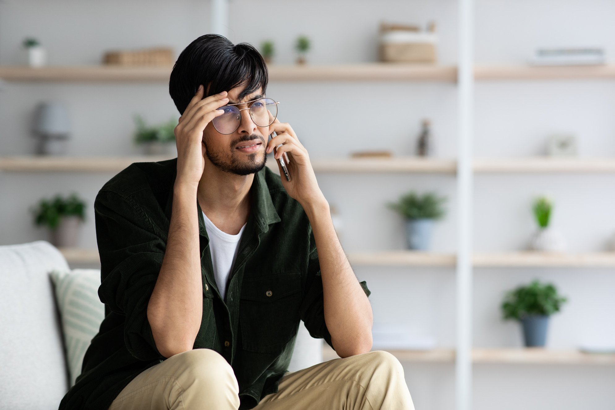 Upset Indian Guy Having Phone Conversation, Home Interior