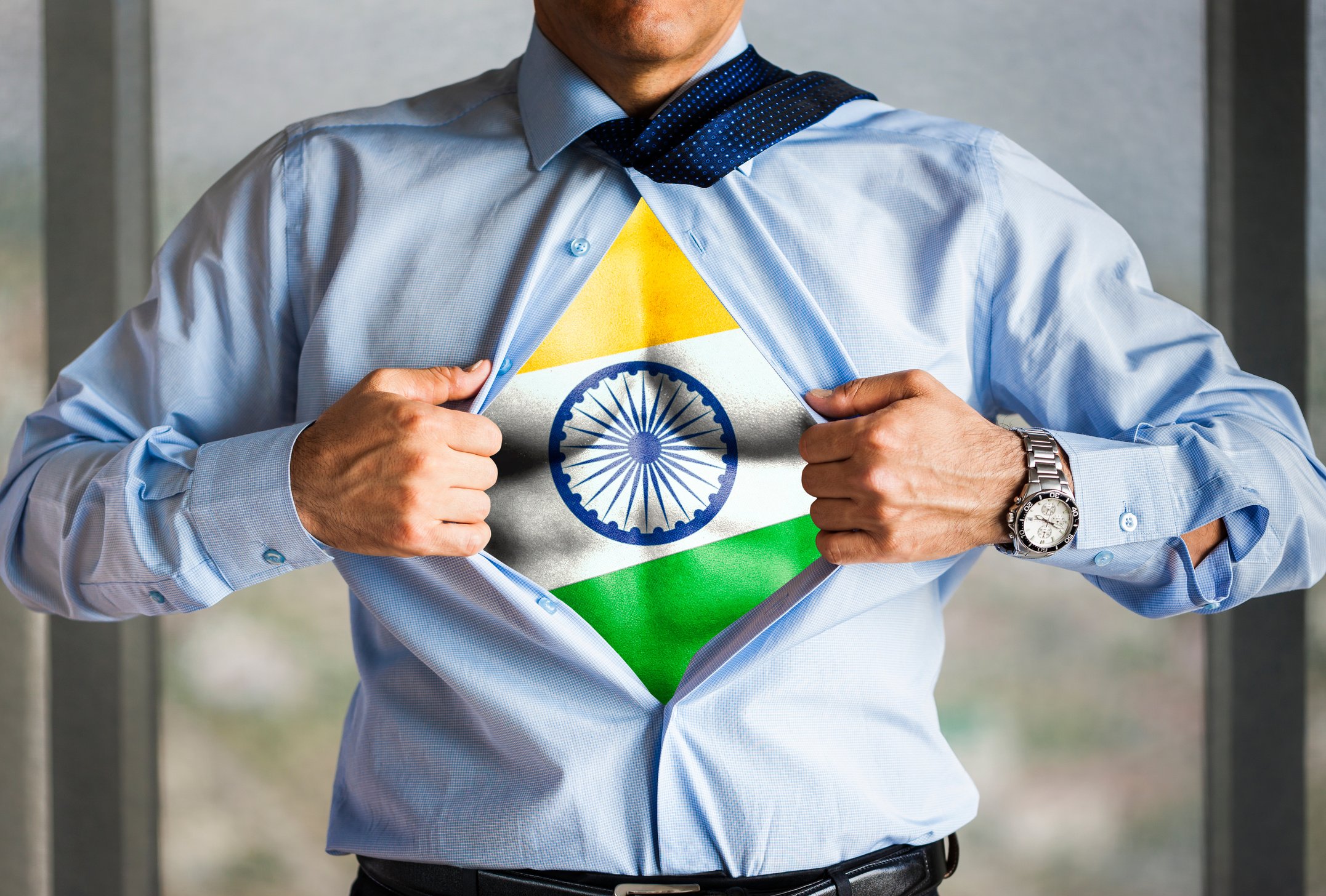 Superhero businessman revealing flag of India